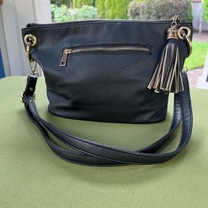 Black leather-like purse with gold zippers and grommet accents